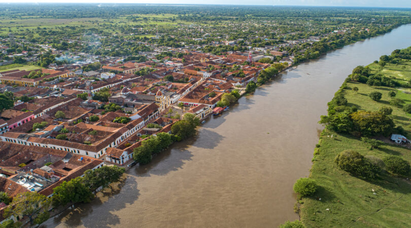 Aerial-view-of-the-historic-town-Santa-Cruz-de-Mompox-in-sunlight-with-river-and-green-sourrounding-World-Heritage