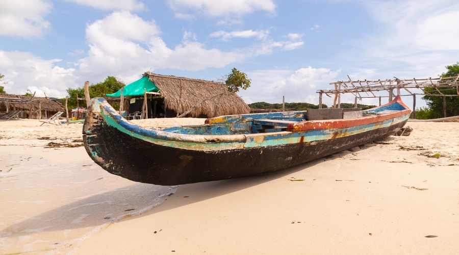 An-old-fishing-boat-built-with-wood-and-painted-in-colors-barada-on-the-beach-of-Isla-Baru