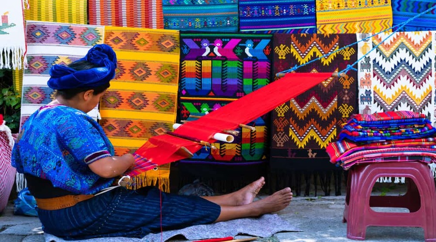 Maya-woman-is-weaving-with-her-waist-loom-on-a-street-in-San-Antonio-Palopo-Guatemala