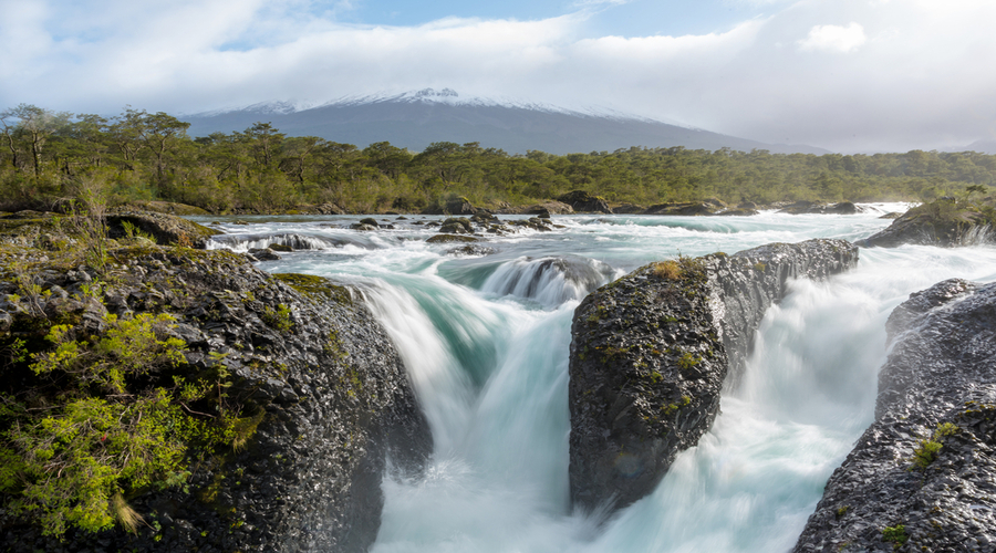 Petrohue Falls and Osorno Volcano with its snowy peak near Puerto Varas, Chile