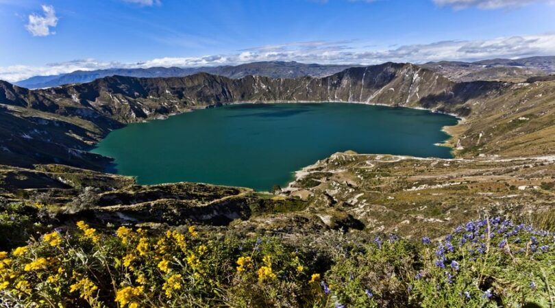 Quilotoa crater lake with flowers in Ecuador, Cotopaxi, Ecuador