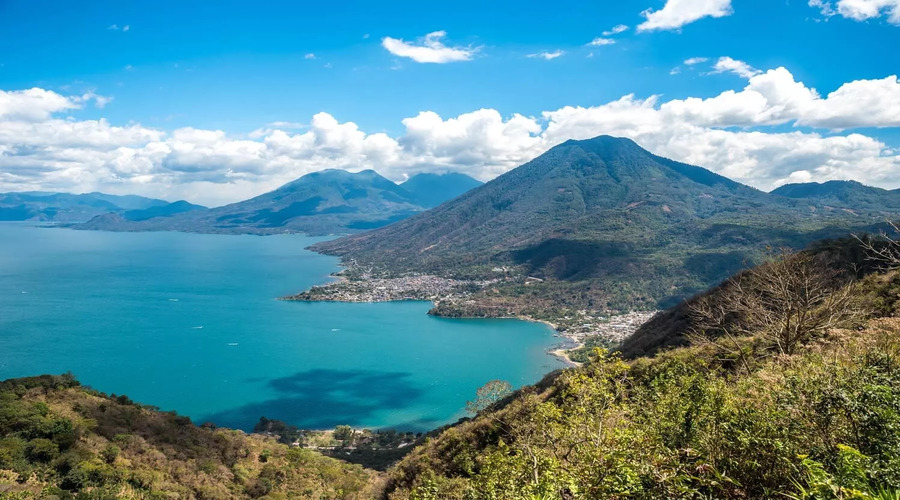 Viewpoint-at-lake-Atitlan-with-the-three-volcanos-San-Pedro-Atitlan-and-Toliman-you-can-see-the-small-villages-San-Pedro-and-San-Juan-at-the-lake-in-the-highlands-of-Guatemala