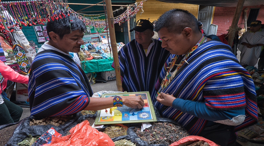  guambiano-men-playing-board-game-in-the-weekly-produce-market