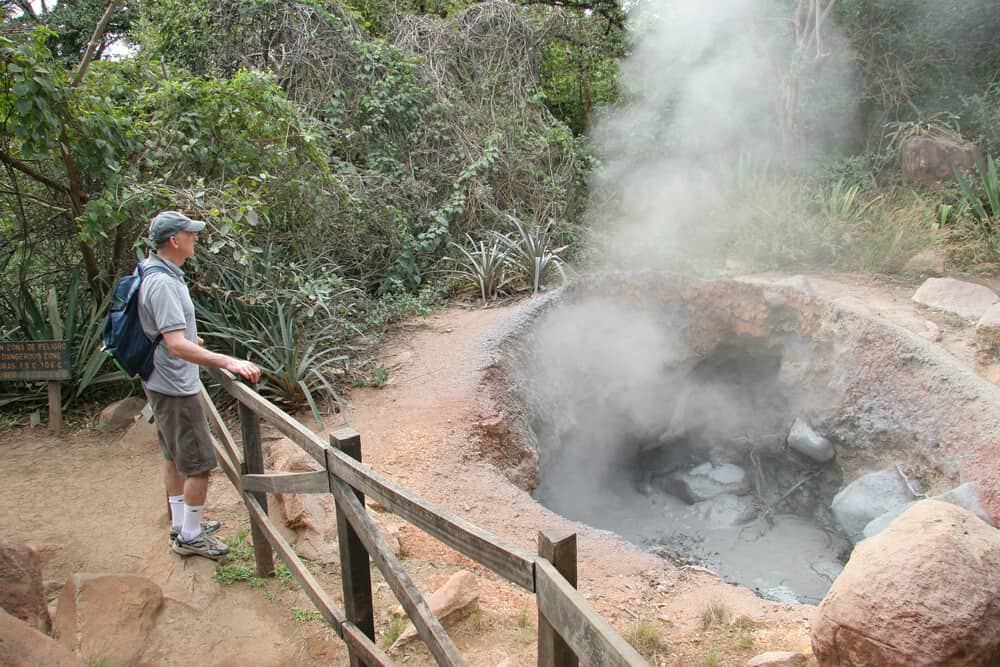 Hiker Viewing Boiling Mud Pot - Rincon de la Vieja, Costa Rica