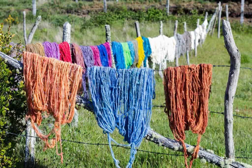 Many-colors-of-sheep-wool-hanging-in-the-sun-to-get-dry.-Countryside-rural-area