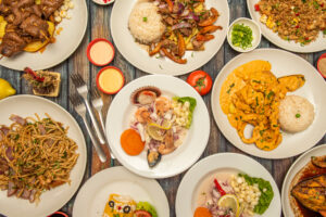 dishes of typical Peruvian restaurant food. Ceviches, lomo saltado, saltado noodles, roast chicken, anticuchos, chaufa rice