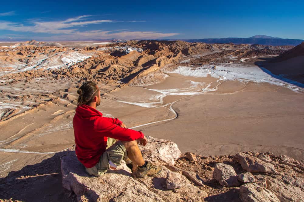 A tourist looks at Moon Valley in the Atacama Desert, Chile