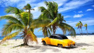 Cayo-Coco-Cuba--Old-car-on-the-cuban-tropical-palm-beach