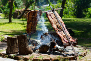 Asado, traditional barbecue dish in Argentina, roasted meat cooked on a crossed vertical grills