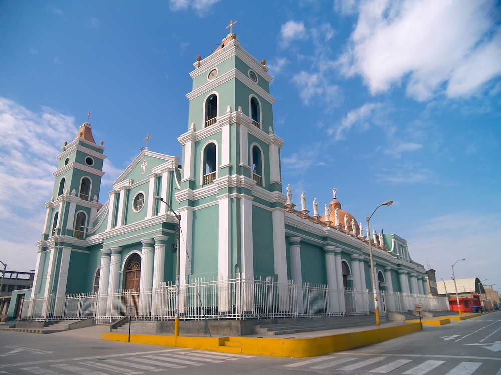 Catacaos, Piura - Peru. Cars circulating in front of the church San Juan Bautista next to the main square in the center of town