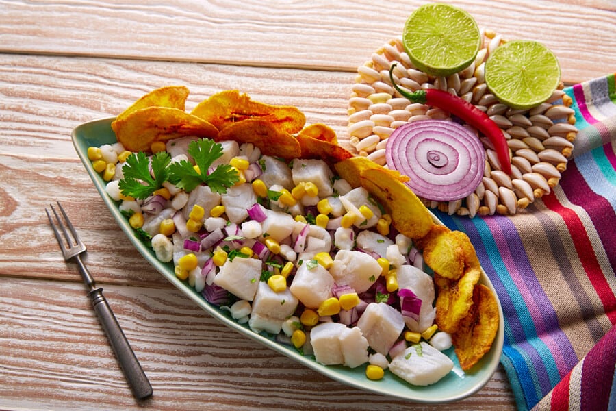 Ceviche-peruvian-recipe-with-fried-banana-and-ingredients-on-wooden-table