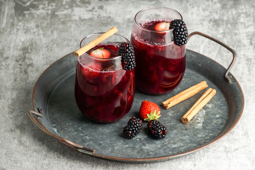 Colada morada - traditional Ecuadorian drink, prepared with black corn flour and fruits such as naranjilla, babaco, pineapple, blackberries, strawberries