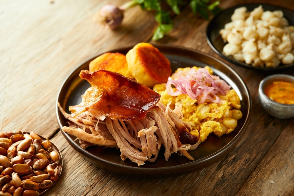 Hornado, a typical Ecuadorian dish that consists on pork cooked on firewood. It’s accompanied by llapingacho and mote pillo. 